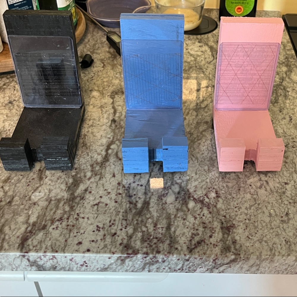 Set of Three Phone Stands in Black, Blue, and Pink
